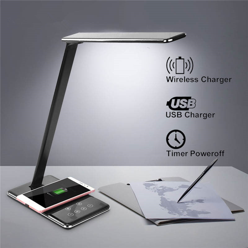 Table lamp with wireless and USB charging capabilities on a gray background