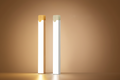 Two cylindrical light fixtures on a beige background